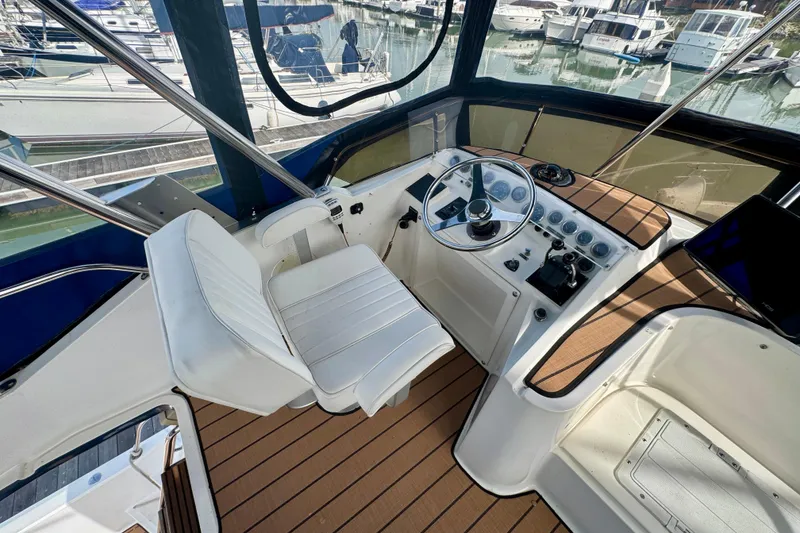 Slide: The Image of Cockpit of 1989 Mediterranean 38 yacht with steering wheel and control panel. - 19