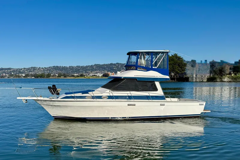 Slide: The Image of 1989 Mediterranean 38 boat cruising on a calm lake under clear blue skies. - 2