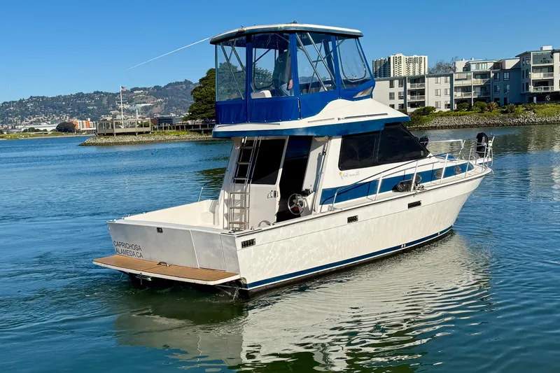 Slide: The Image of 1989 Mediterranean 38 yacht on calm water near urban shoreline. - 4