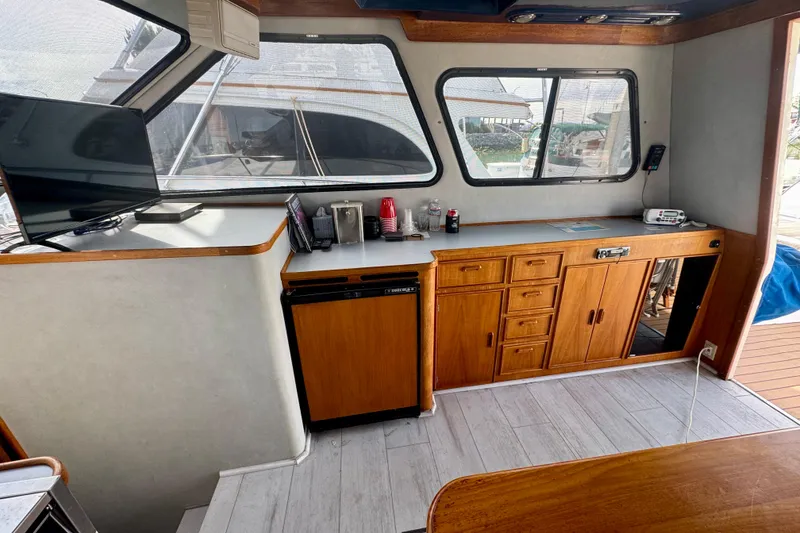 Slide: The Image of Interior of 1989 Mediterranean 38 boat with wooden cabinets and modern amenities. - 9