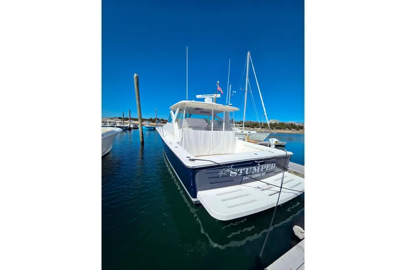 Slide: The Image of 2012 Tiara Yachts 3900 Open docked in a marina under clear blue skies. - 1