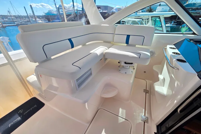 Slide: The Image of Luxurious seating area on a 2012 Tiara Yachts 3900 Open, docked at a marina. - 10