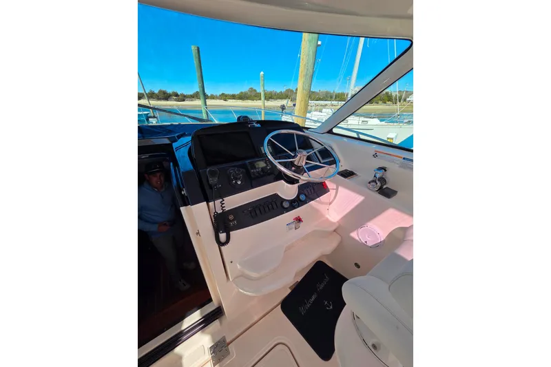 Slide: The Image of Helm of 2012 Tiara Yachts 3900 Open with steering wheel and navigation controls. - 14
