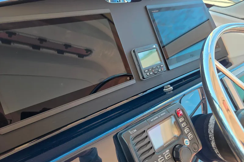 Slide: The Image of Helm of 2012 Tiara Yachts 3900 Open with navigation screens and controls. - 16