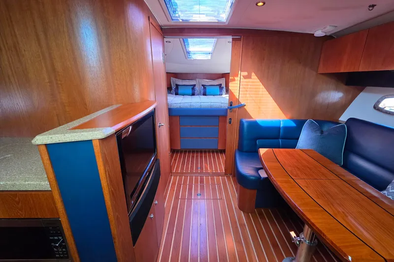 Slide: The Image of Luxurious interior of 2012 Tiara Yachts 3900 Open, featuring wood finishes and cozy seating. - 17