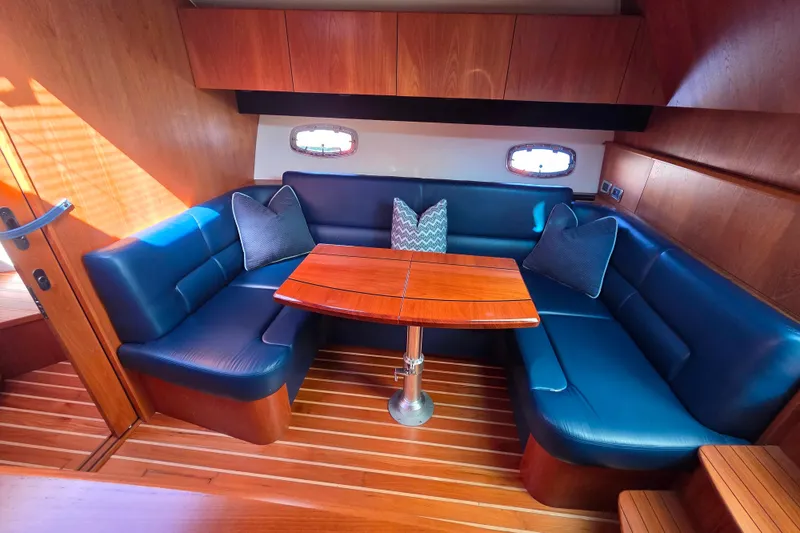 Slide: The Image of Luxurious interior of 2012 Tiara Yachts 3900 Open with blue seating and wooden table. - 18