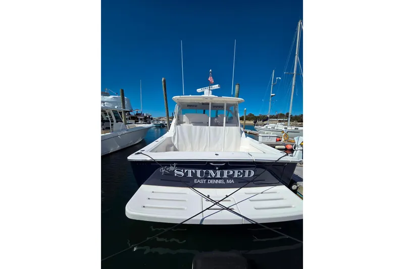 Slide: The Image of 2012 Tiara Yachts 3900 Open docked, rear view with "Stumped" name visible. - 2