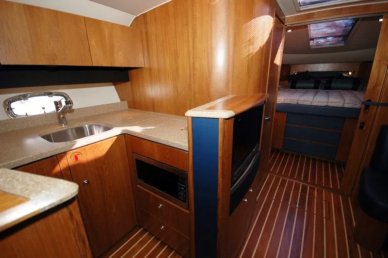 Slide: The Image of Interior of 2012 Tiara Yachts 3900 Open with kitchen and sleeping area. - 21