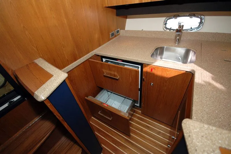 Slide: The Image of Interior of 2012 Tiara Yachts 3900 Open with kitchenette and sink. - 23
