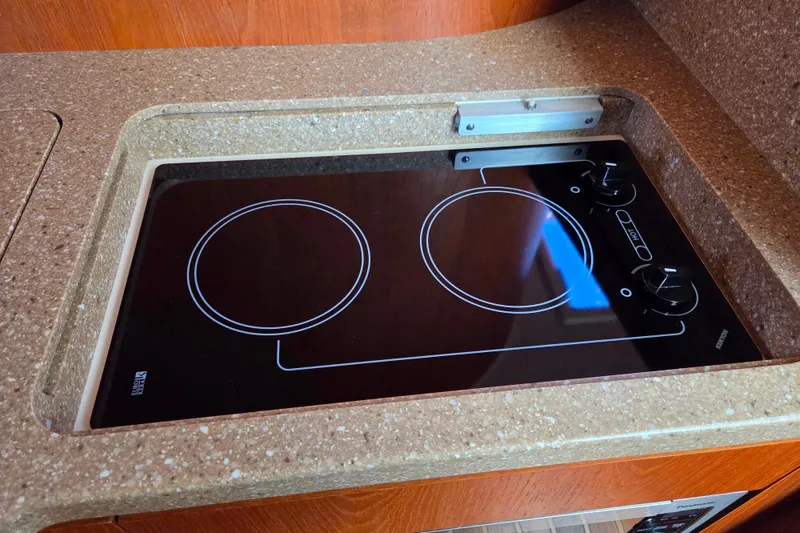 Slide: The Image of Built-in electric stove on 2012 Tiara Yachts 3900 Open, featuring two burners and sleek design. - 25