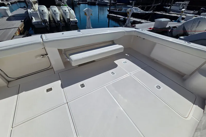 Slide: The Image of Spacious deck of 2012 Tiara Yachts 3900 Open, featuring clean white seating and storage. - 4