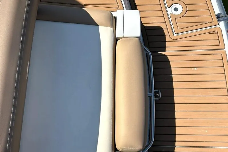 Slide: The Image of 2019 Crownline Eclipse E285 boat interior with tan seating and wooden deck. - 21
