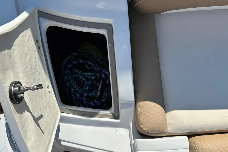 Slide: The Image of 2019 Crownline Eclipse E285 boat storage compartment with rope and seating area. - 23