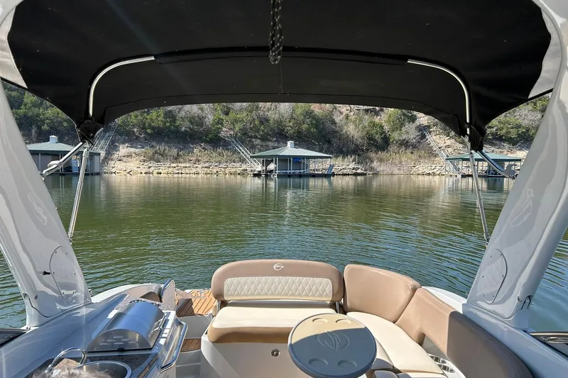 Slide: The Image of 2019 Crownline Eclipse E285 boat interior with lake view and docked boathouses. - 26
