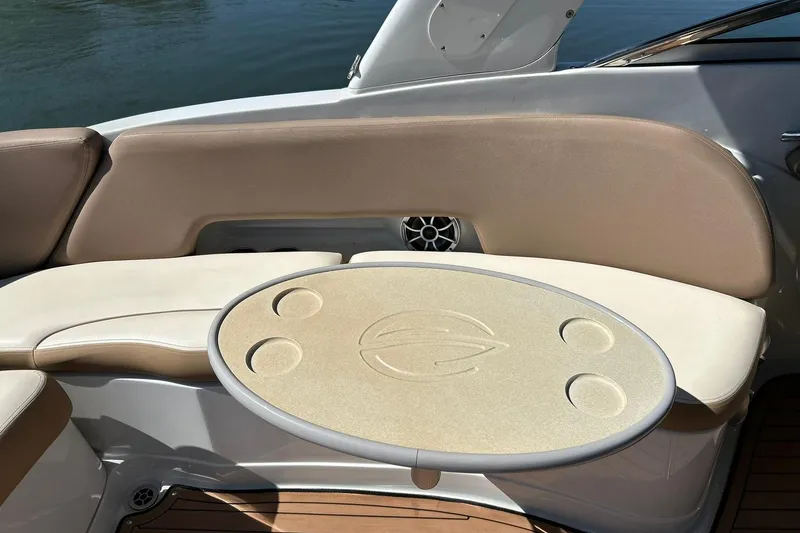 Slide: The Image of 2019 Crownline Eclipse E285 boat interior with beige seating and oval table. - 27