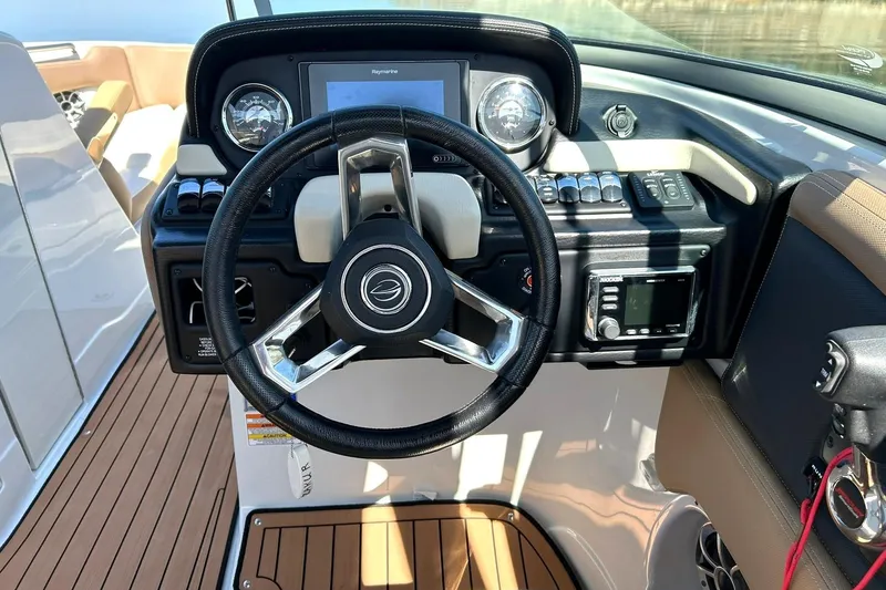Slide: The Image of 2019 Crownline Eclipse E285 boat dashboard with steering wheel and controls. - 37