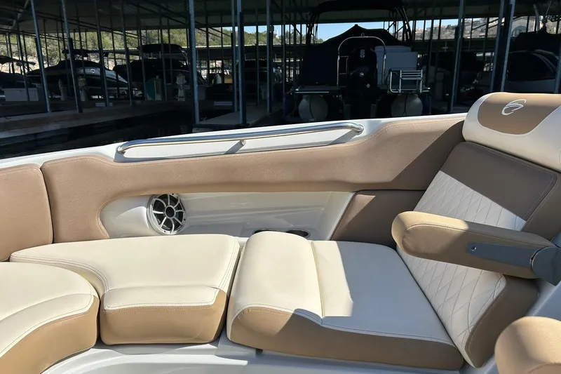 Slide: The Image of 2019 Crownline Eclipse E285 boat interior with beige seating and speaker detail. - 42