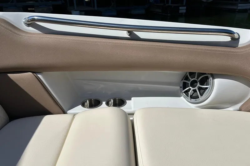 Slide: The Image of 2019 Crownline Eclipse E285 boat interior with cup holders and speaker. - 43