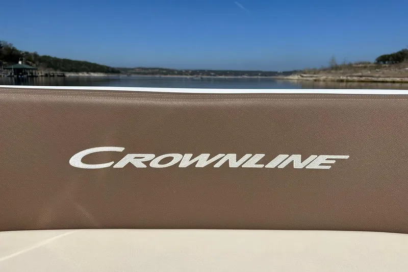 Slide: The Image of 2019 Crownline Eclipse E285 boat logo with scenic lake background. - 48