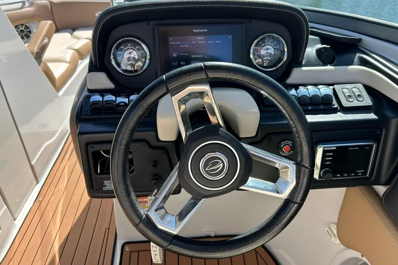 Slide: The Image of 2019 Crownline Eclipse E285 boat dashboard with steering wheel and control panel. - 5