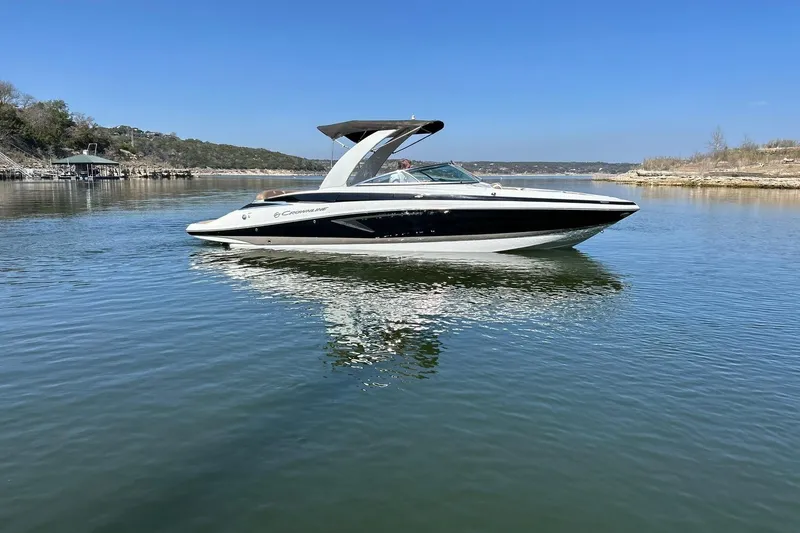 Slide: The Image of 2019 Crownline Eclipse E285 boat on calm lake under clear blue sky. - 7
