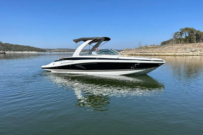 Slide: The Image of 2019 Crownline Eclipse E285 boat on calm lake with clear blue sky. - 8