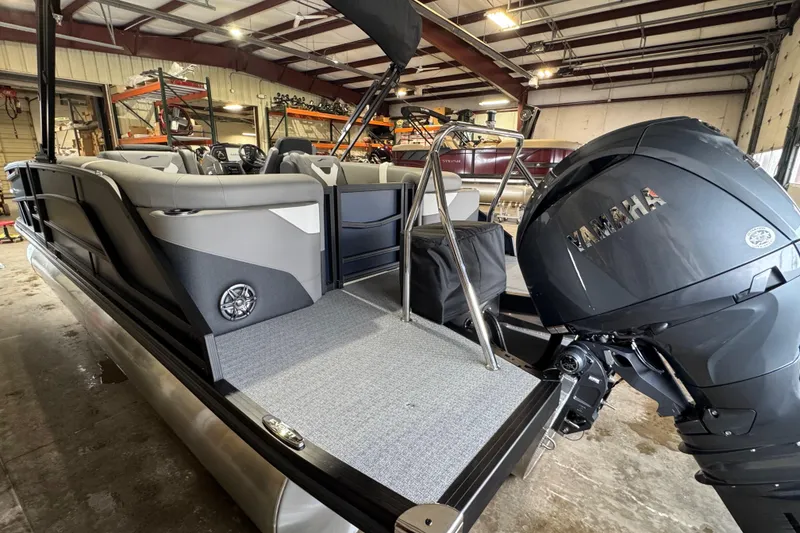 Slide: The Image of 2026 Evotti 521QL pontoon boat with Yamaha engine in a warehouse setting. - 11