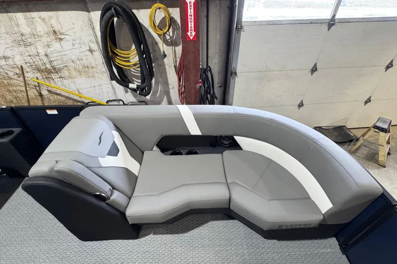 Slide: The Image of Gray Evotti 521QL 2026 boat seating with cup holders in a garage setting. - 3