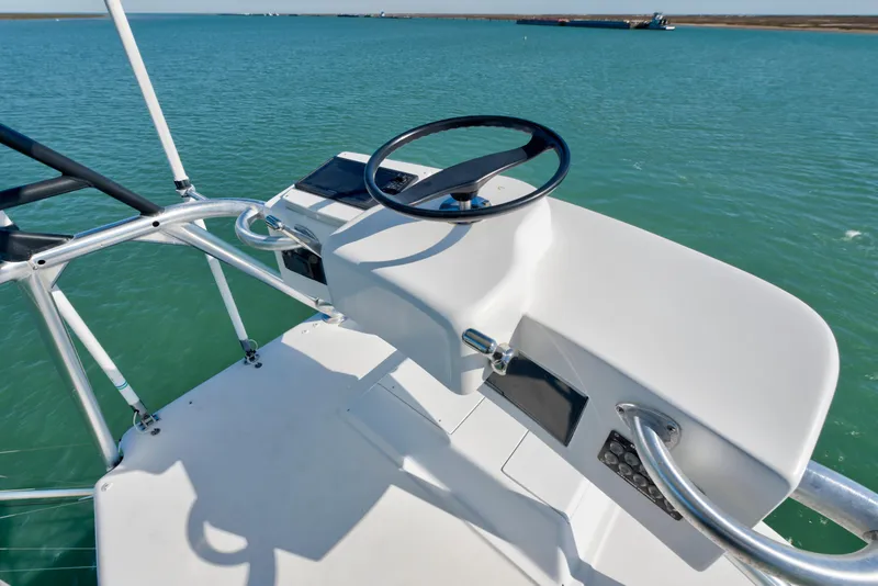 Slide: The Image of 2002 Viking Convertible boat helm with steering wheel on calm water. - 10