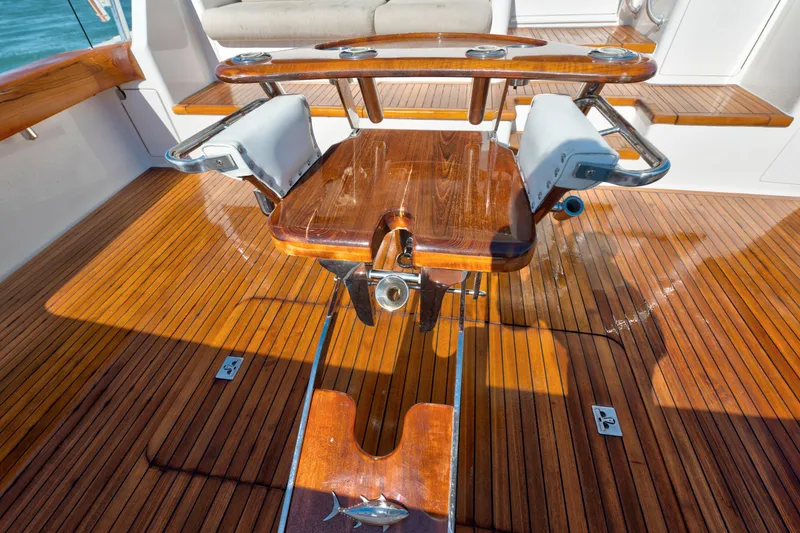 Slide: The Image of 2002 Viking Convertible boat with polished wooden deck and fishing chair. - 15