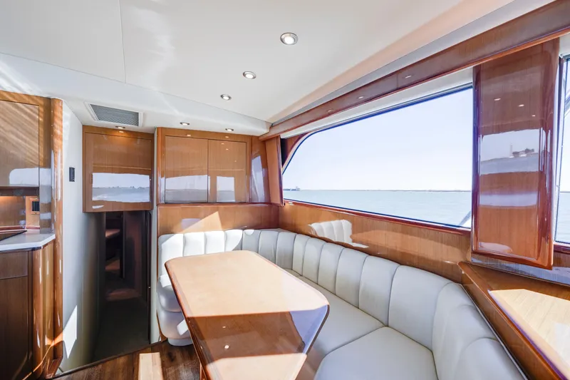 Slide: The Image of Luxurious interior of a 2002 Viking Convertible yacht with elegant wood finishes and ocean view. - 20