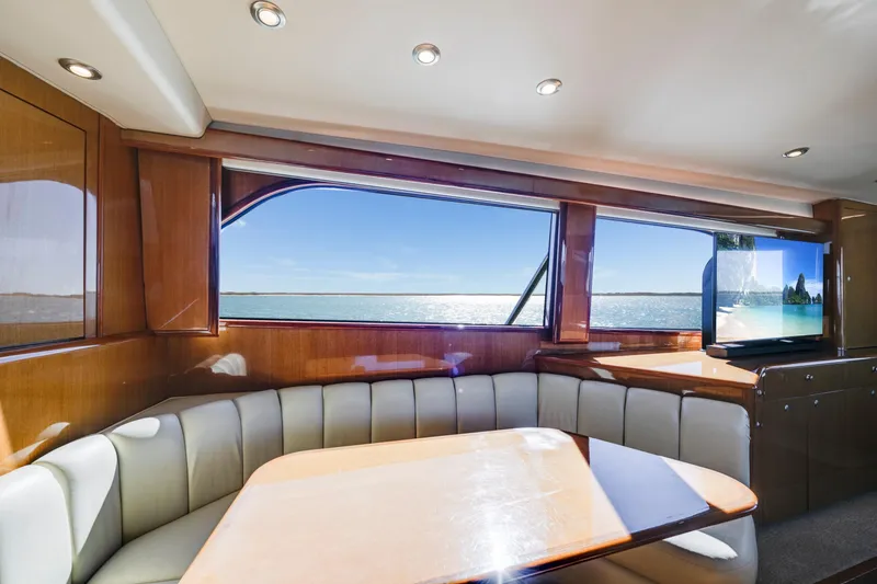 Slide: The Image of Luxurious interior of 2002 Viking Convertible yacht with ocean view and elegant seating area. - 21
