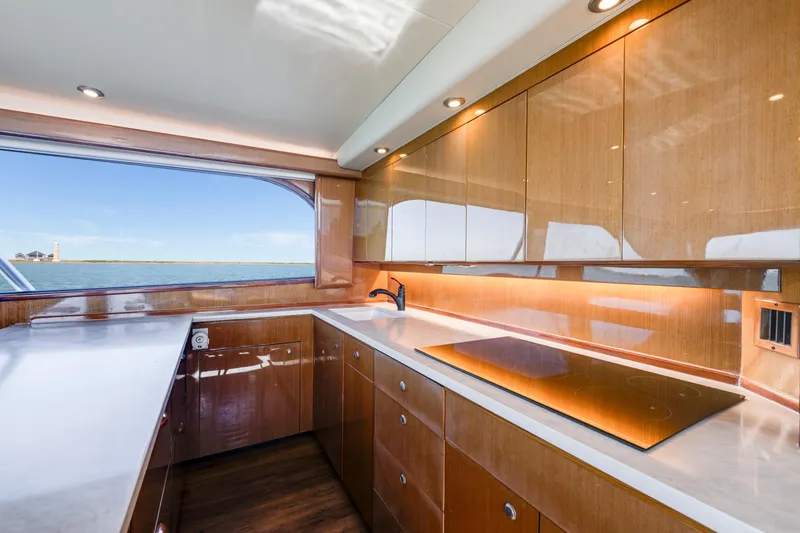 Slide: The Image of Luxurious kitchen interior of a 2002 Viking Convertible yacht with ocean view. - 24