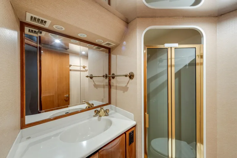 Slide: The Image of Luxurious bathroom in 2002 Viking Convertible yacht with shower and vanity. - 33