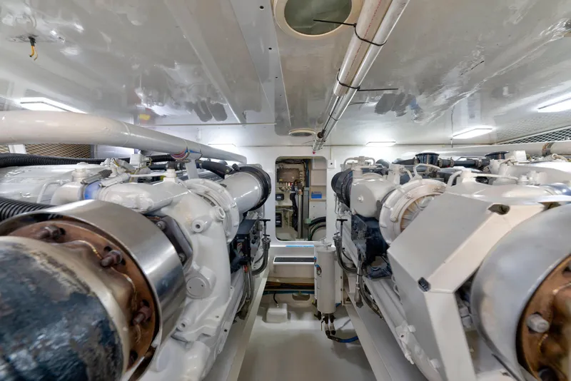 Slide: The Image of Engine room of a 2002 Viking Convertible yacht, showcasing dual engines and mechanical components. - 35