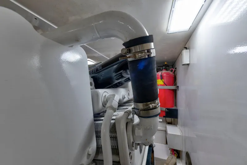 Slide: The Image of Engine room of a 2002 Viking Convertible boat with visible piping and fire extinguisher. - 40