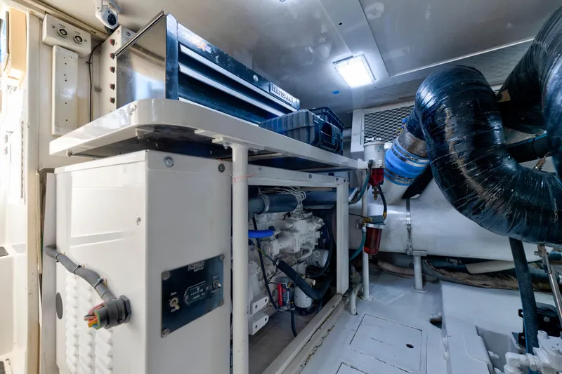 Slide: The Image of Engine room of a 2002 Viking Convertible yacht, featuring mechanical components and ventilation. - 42