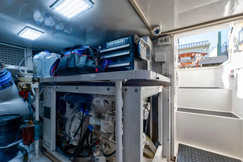 Slide: The Image of Engine room of a 2002 Viking Convertible boat with tools and equipment. - 43