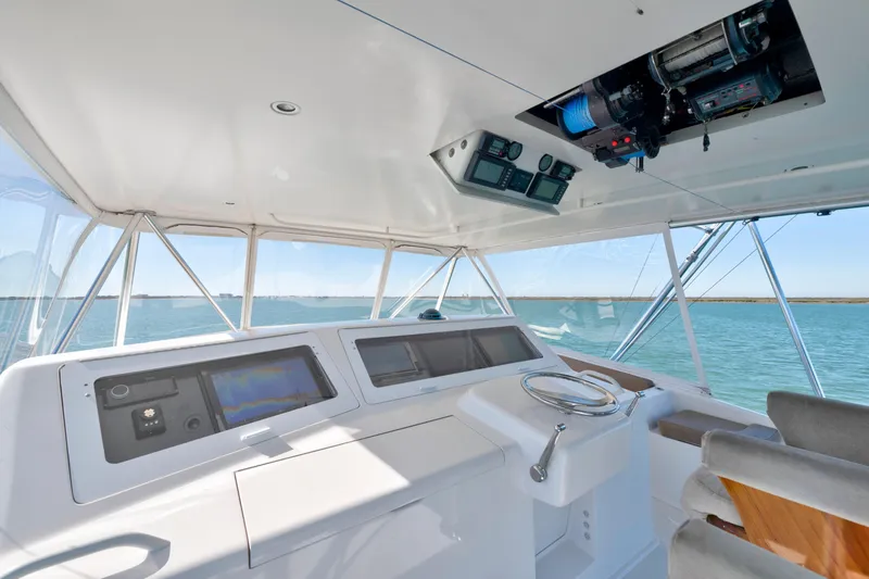 Slide: The Image of Interior view of a 2002 Viking Convertible yacht cockpit with navigation equipment. - 6