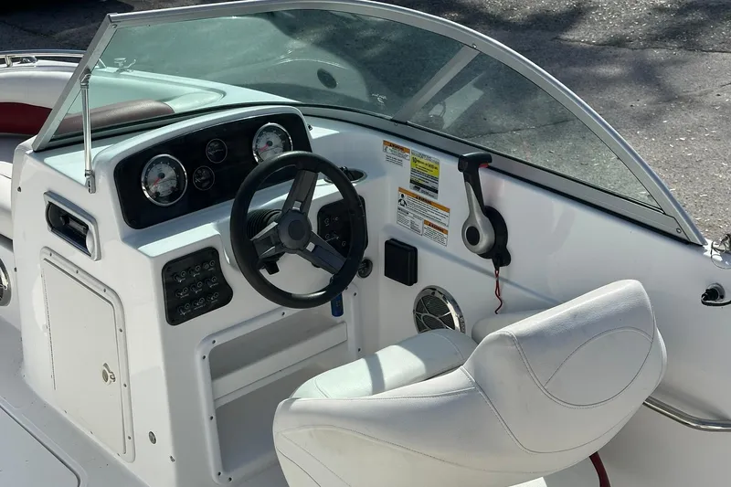 Slide: The Image of 2016 Hurricane SunDeck 187 OB boat cockpit with steering wheel and control panel. - 10