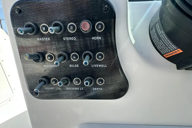 Slide: The Image of Control panel of a 2016 Hurricane SunDeck 187 OB boat with labeled switches. - 11