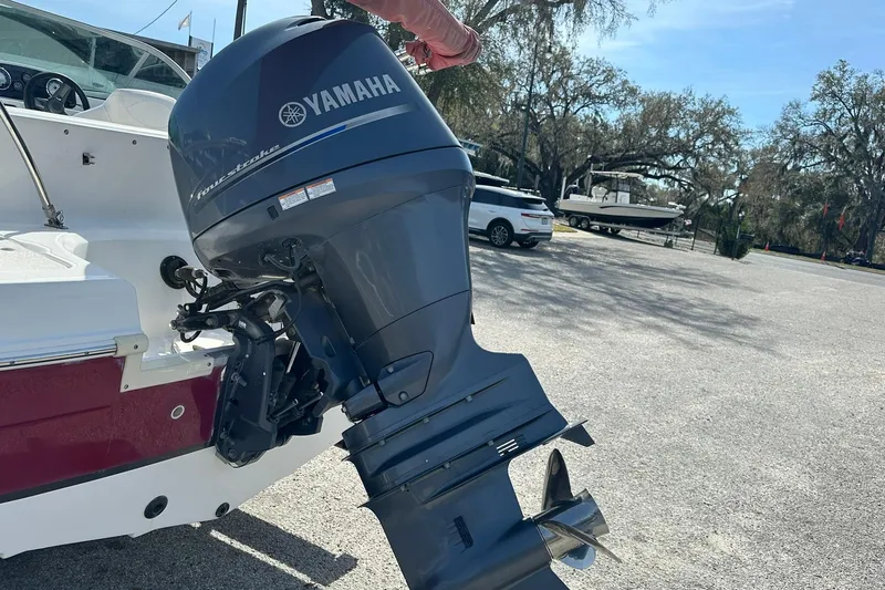 Slide: The Image of 2016 Hurricane SunDeck 187 OB with Yamaha outboard motor in a parking area. - 16