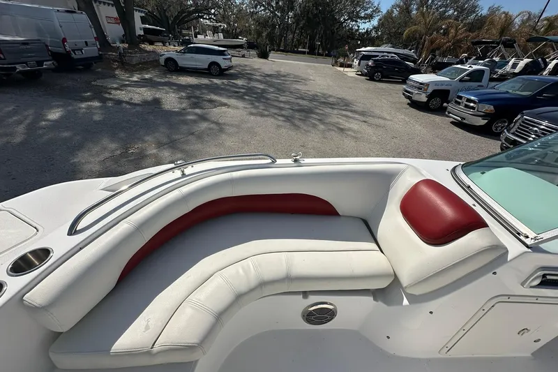 Slide: The Image of 2016 Hurricane SunDeck 187 OB boat with white and red seating, parked in a lot. - 7