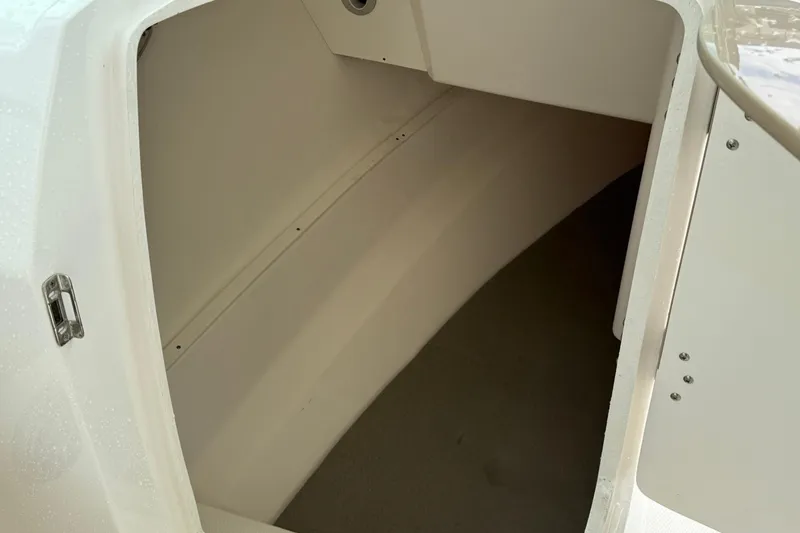 Slide: The Image of 2024 Robalo R317 Dual Console storage compartment interior view. - 16