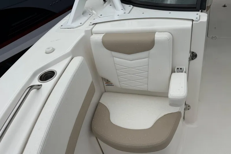 Slide: The Image of 2024 Robalo R317 Dual Console boat seat with beige and white upholstery. - 18