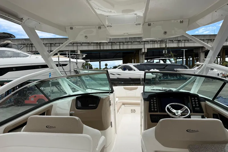 Slide: The Image of 2024 Robalo R317 Dual Console boat interior with modern dashboard and seating. - 19