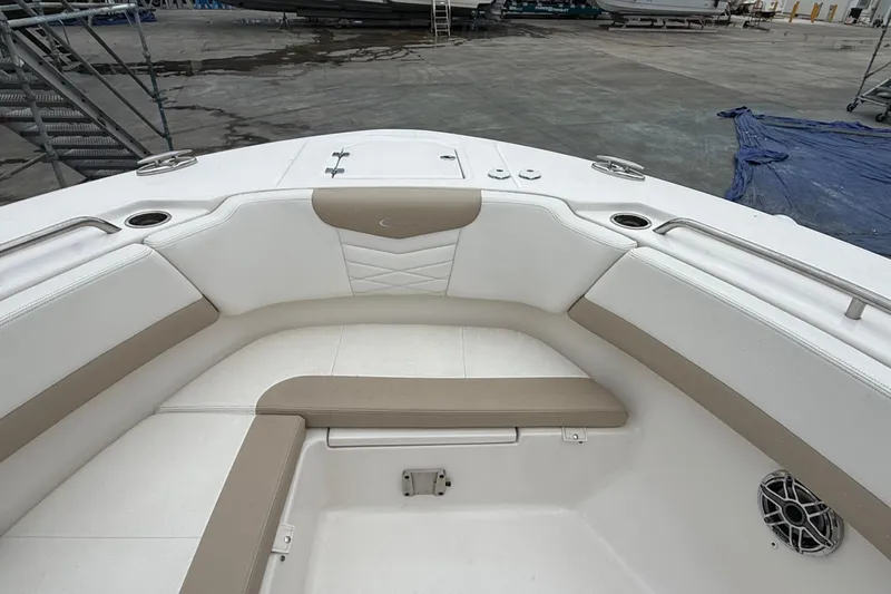 Slide: The Image of 2024 Robalo R317 Dual Console boat interior with cushioned seating and cup holders. - 21
