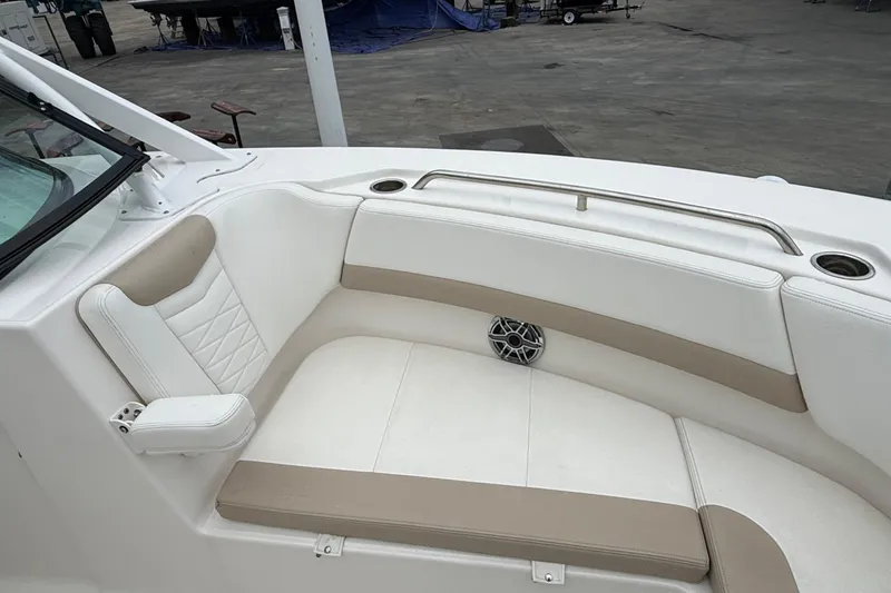 Slide: The Image of 2024 Robalo R317 Dual Console boat interior with cushioned seating and cup holders. - 22
