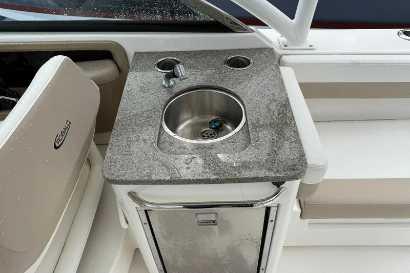 Slide: The Image of 2024 Robalo R317 Dual Console boat with wet bar and stainless steel sink. - 4