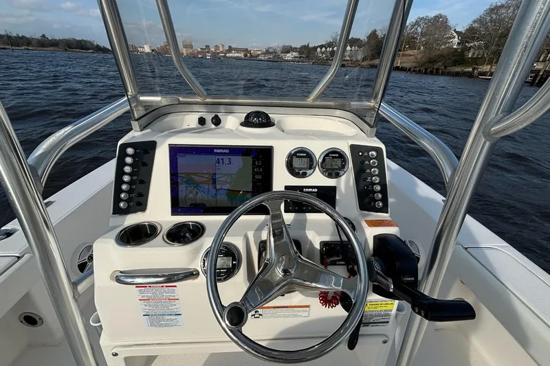 Slide: The Image of 2020 Robalo 226 Cayman boat dashboard with steering wheel and navigation system. - 10